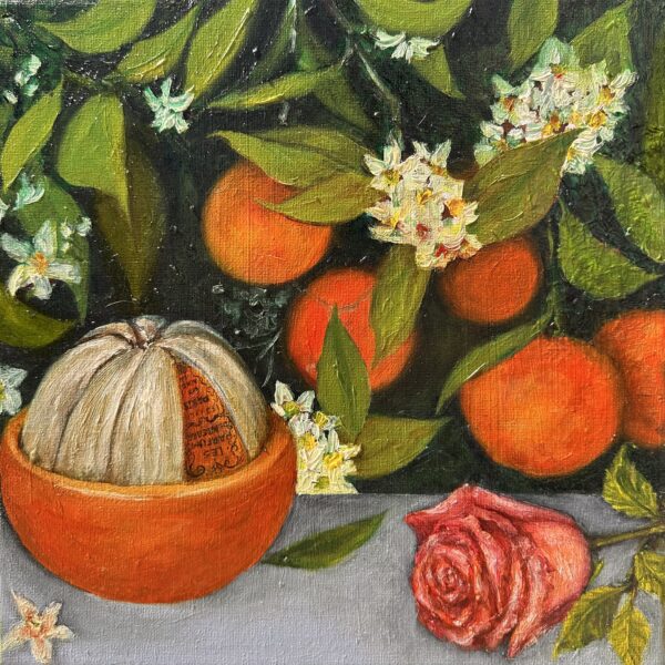 Still life of an orange vintage perfume with orange grove background and rose in the foreground